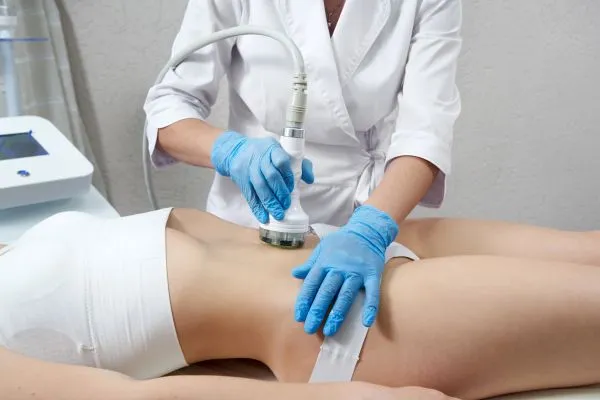 Lost the Weight but Not the Loose Skin? 2 woman having HIFU treatment on her stomach to combat loose skin Wales following weight loss